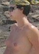 Charlize Theron in bikini & topless on a beach pics