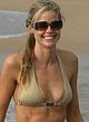 Denise Richards in shorts and bra on a beach pics