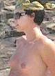 Charlize Theron sunbathes topless & bikini pics