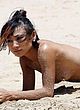 Bai Ling sunbathes topless on a beach pics
