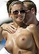 Oksana Andersson sunbathes topless on a beach pics
