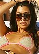 Kourtney Kardashian sunbathes in bikini on a beach pics