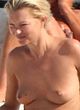 Kate Moss sunbathes topless on a yacht pics