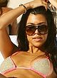 Kourtney Kardashian sunbathes in bikini on a beach pics