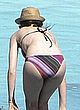 Anne Hathaway sunbathes in bikini on a beach pics