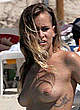 Alice Dellal caught topless on the beach pics