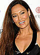 Tia Carrere shows slight cleavage and legs pics