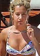 Ashley Tisdale rubbing a cream while tanning pics