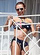 Melanie Brown in skimpy bikini on a balcony pics