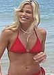 Brooke Burns red hot bikini at beach scenes pics