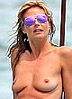 Heidi Klum naked pics - sunbathing topless on a beach