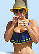 Kaley Cuoco wearing a bikini at a pool pics