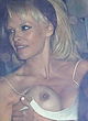 Pamela Anderson naked pics - boob-slip in the car