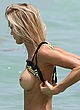Joy Corrigan posing topless at the beach pics