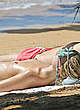 Margot Robbie sunbathing topless on a beach pics
