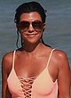 Kourtney Kardashian busty in a plunging swimsuit pics