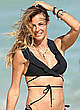 Kelly Bensimon in black bikini on a beach pics