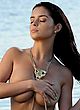 Demi Rose strips her bikini top at beach pics