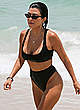 Kourtney Kardashian in black bikini on a beach pics