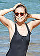 Olivia Wilde in black swimsuit on a beach pics
