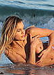Joy Corrigan topless on a beach photoshoot pics