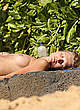 Toni Garrn sunbathing topless on a beach pics