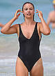 Elise Stacy in black swimsuit on a beach pics