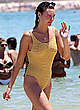 Montana Cox in yellow swimsuit on a beach pics