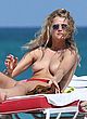 Toni Garrn exposes boobs while sunbathing pics