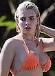Megan Barton busty in orange string bikini pics