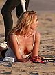 Stella Maxwell flashing breast at the beach pics