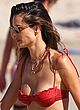 Alessandra Ambrosio busty in a tiny red bikini pics