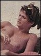 Helena Christensen caught topless on the beach pics