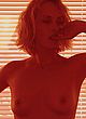 Amber Valletta exposing tits in magazine pics