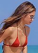 Jocelyn Chew busty in a red thong bikini pics