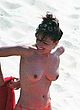 Elizabeth Hurley posing topless on the beach pics