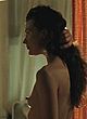 Milla Jovovich showing small tits in movie pics