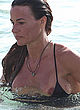 Kelly Bensimon naked pics - nipple slips in black swimsuit