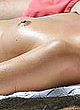 Margot Robbie lying topless on the beach pics