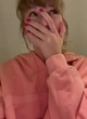 Taylor Swift wearing a peach-colored hoodie pics