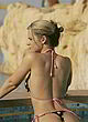 Emily Oldfield topless in a pool, sexy bikini pics