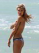 Joy Corrigan goes topless on the beach pics