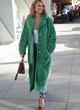 Chrissy Teigen wearing a long green coat pics