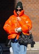 Dua Lipa dazzling orange puffer jacket pics