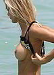 Joy Corrigan topless in water, photoshoot pics