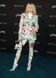 Miley Cyrus posing in a floral pantsuit pics