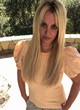 Britney Spears posing in peach-colored shirt pics