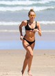 Miley Cyrus models black bikini on beach pics