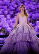 Taylor Swift performs in a purple gown pics