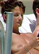 Helena Christensen naked pics - sunbathes topless on a beach